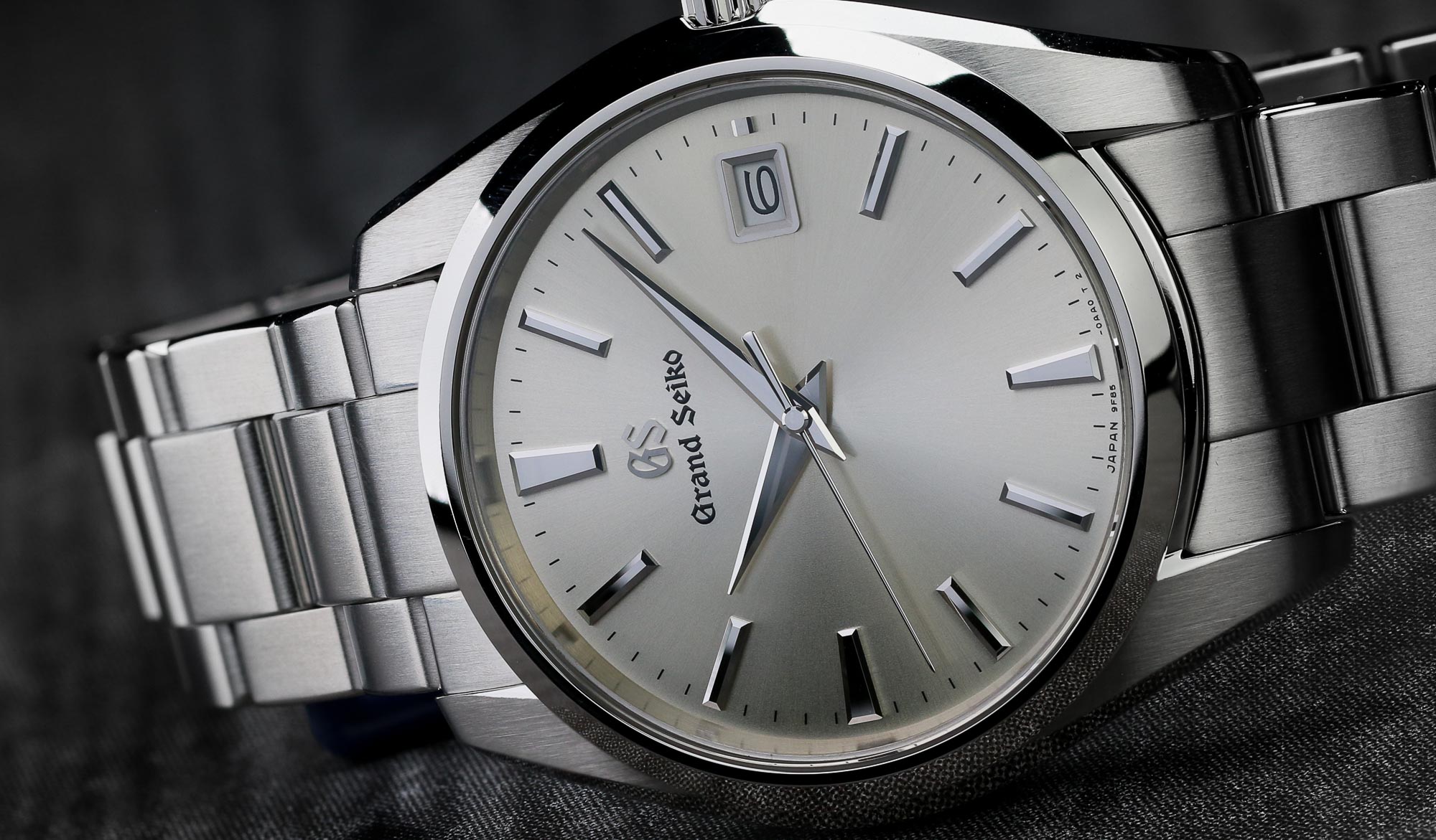 Closeup of the dial of Grand Seiko SBGP009 stainless steel wristwatch with silver dial.